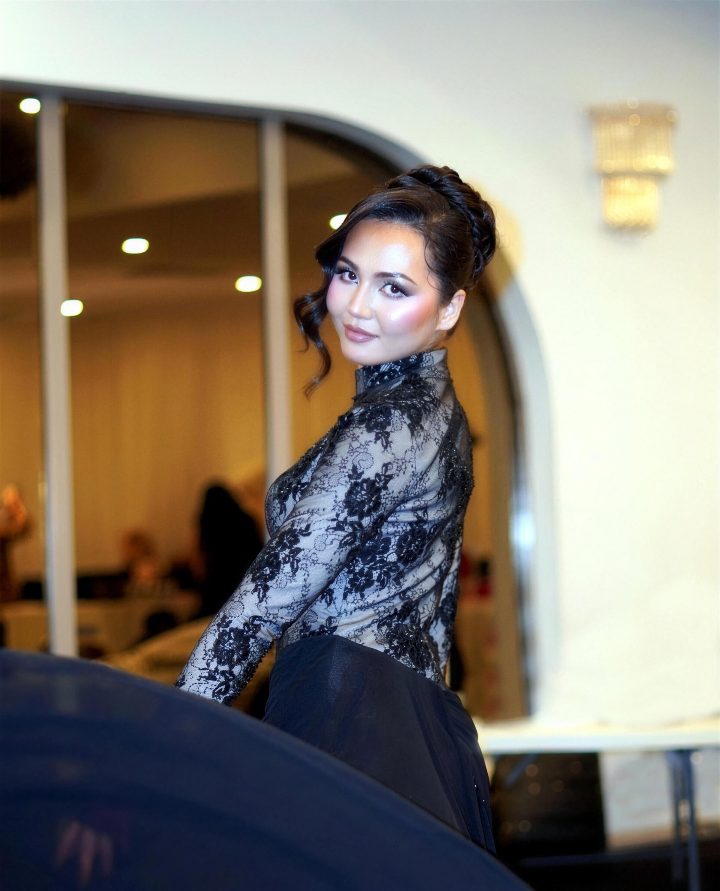 A model in a champagne beaded modest gown — RAIÉ Couture editorial